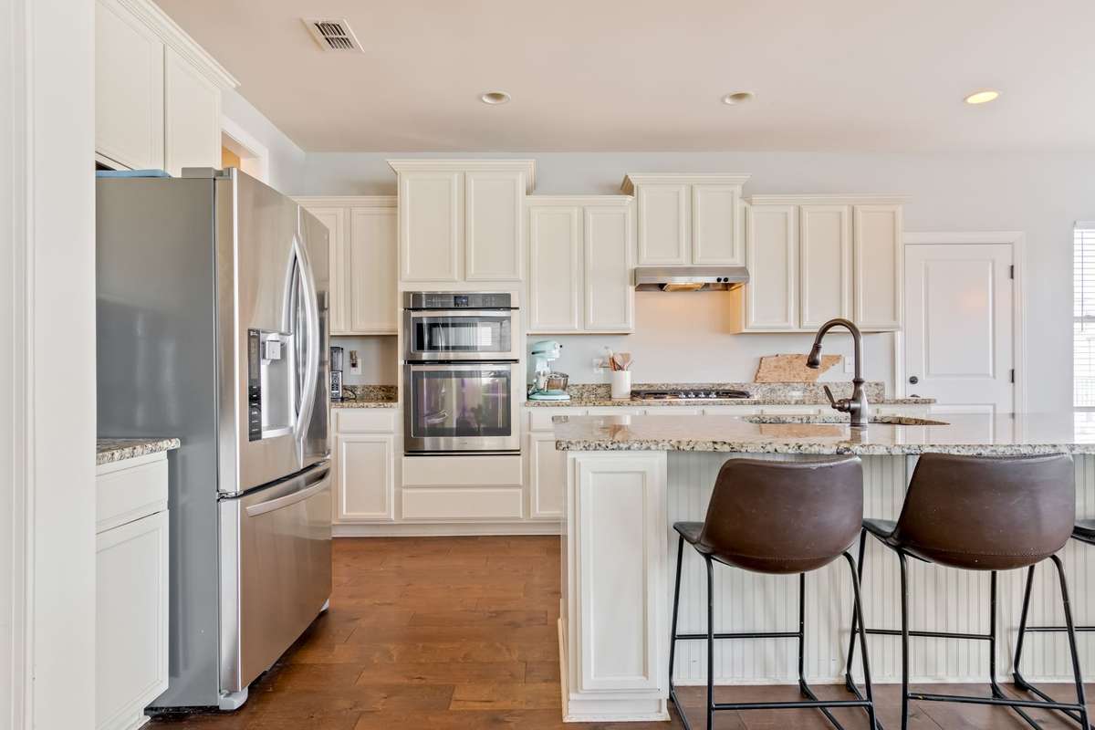 There are lots of kitchen cabinets and a walk-in pantry (not pictured) is located between the kitchen and the dining room.
