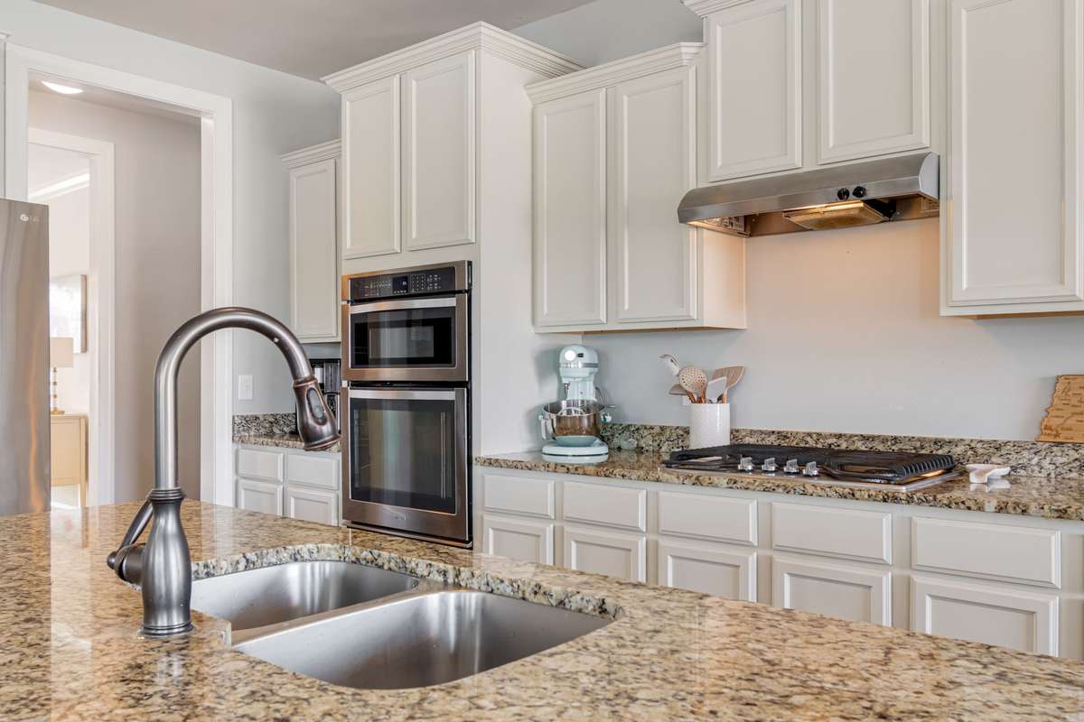 A gas stove for the family chef! SS appliances and a two bowl sink for convenience in cooking and prepping your meals. The refrigerator WILL convey with the home.