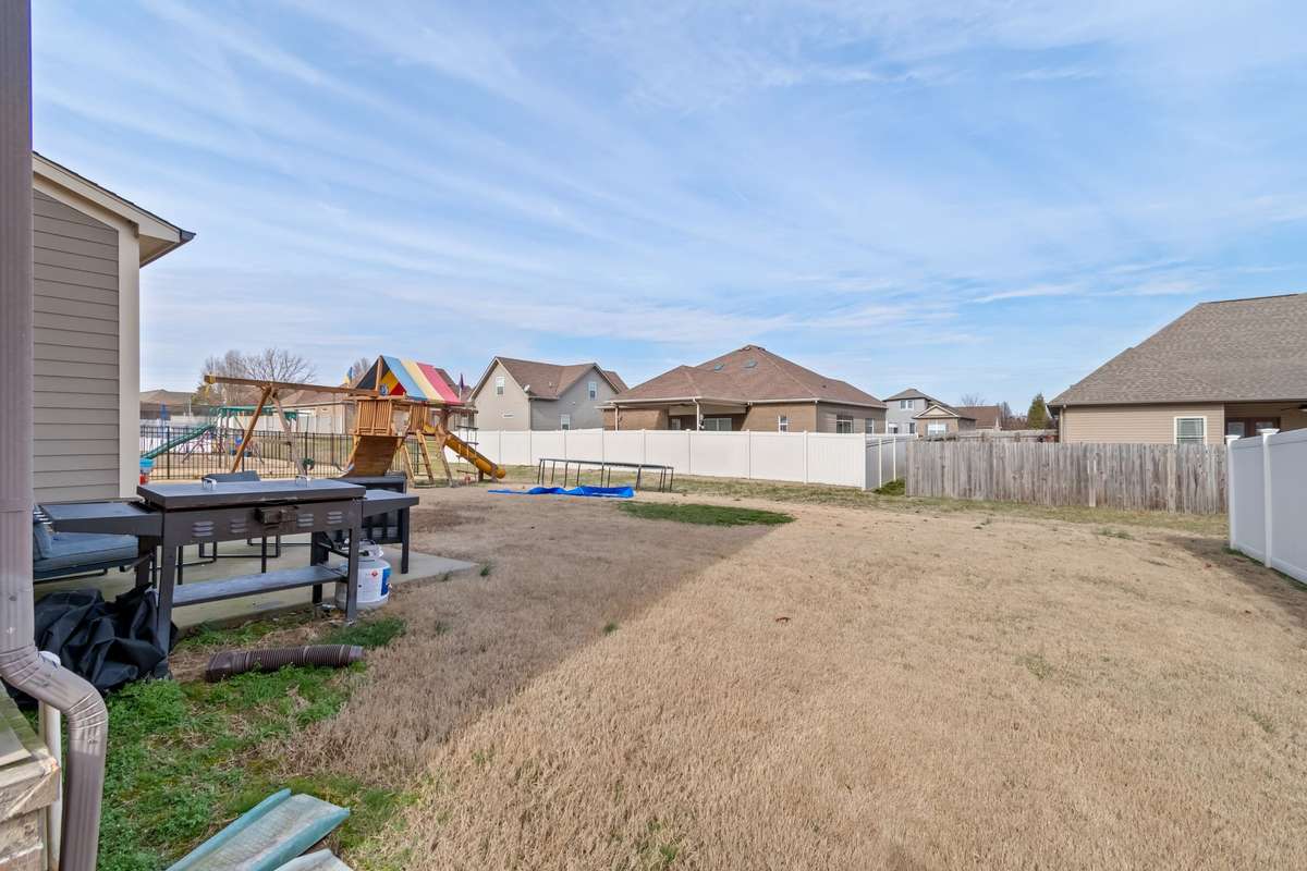 The play set is negotiable and this photo demonstrates that the lawn is large enough for the play set and the trampoline. This lot is not a "postage stamp!"