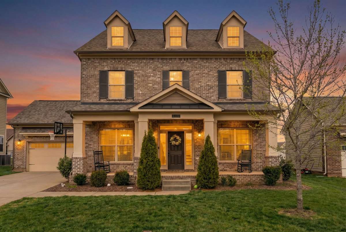 A twilight photo emphasizes the expansive size of this home.