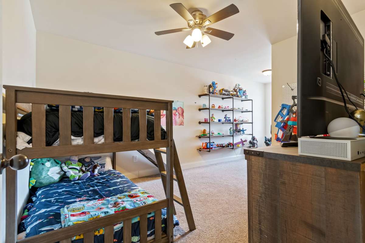 The second bedroom has room for these large bunkbeds, dresser and the built in shelving pictured here will convey with the home. This home is located at the rear of the home.