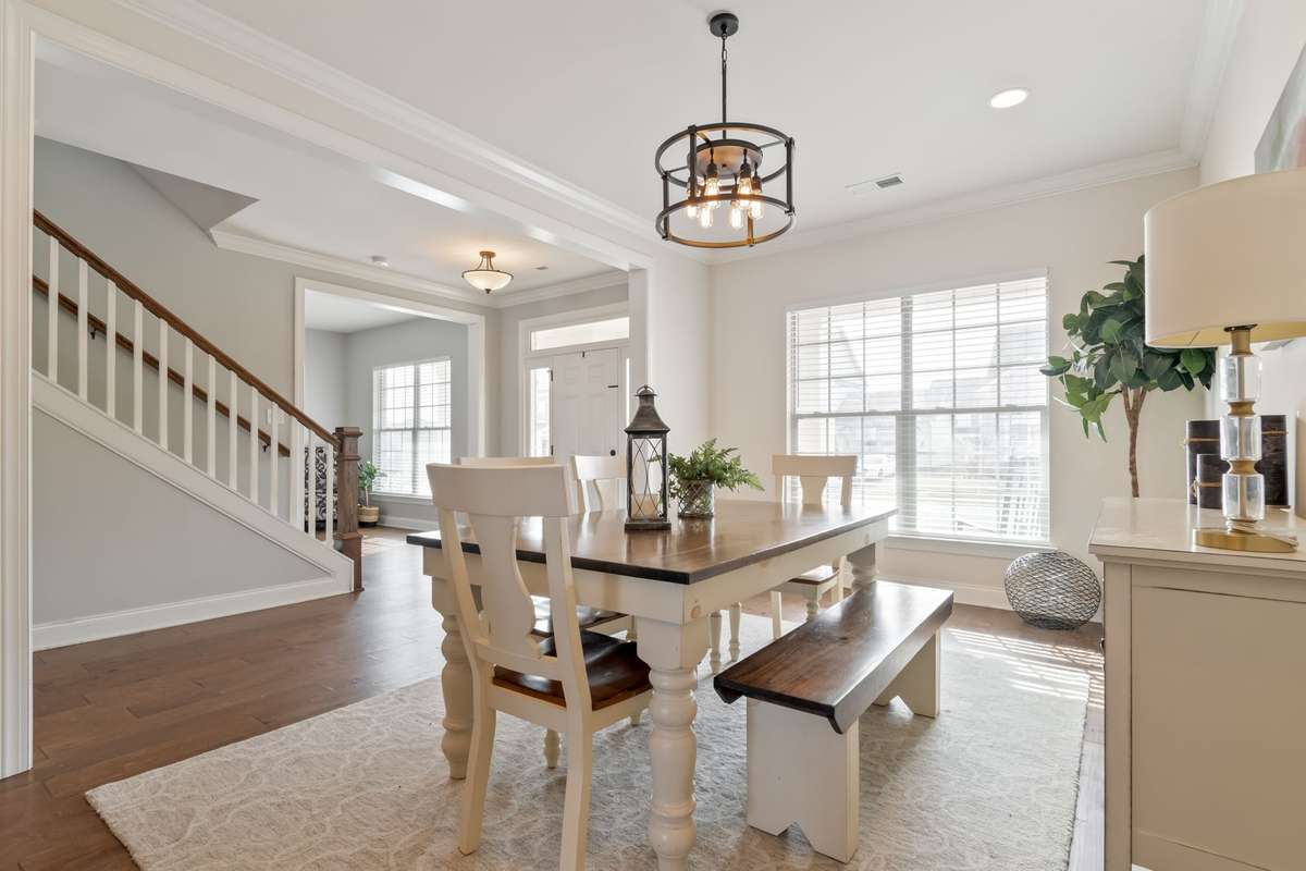 Another large front window ushers in natural light to this room.