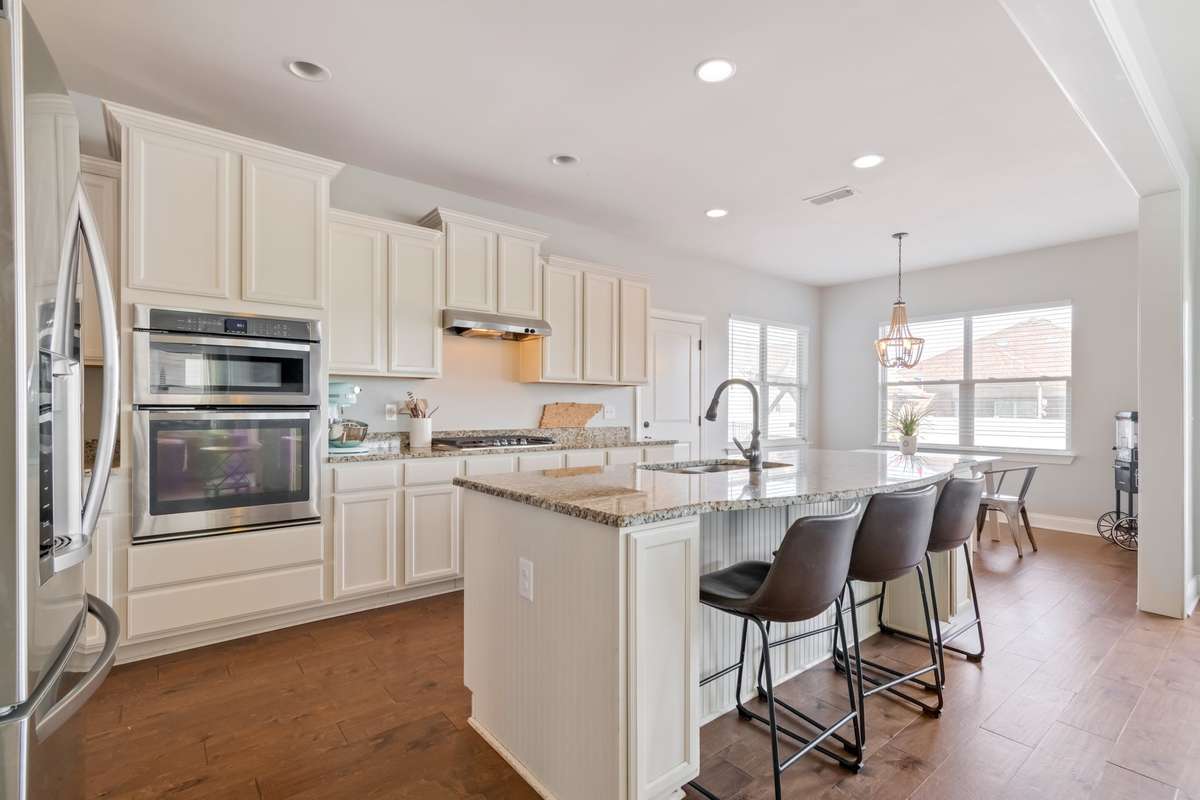 This lovely kitchen provides counter seating for grabbing a quick snack AND ample space for your kitchen table when gathering for family meals and entertaining.