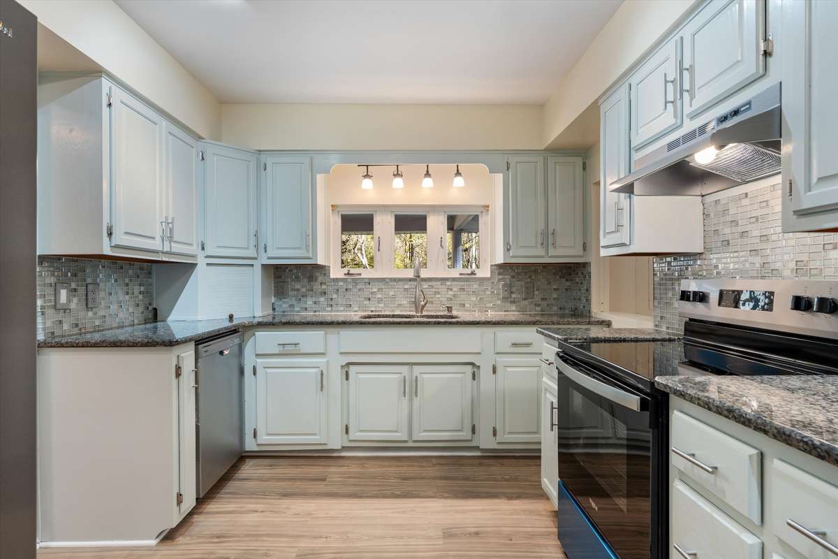 *LARGE KITCHEN WITH ALL NEW APPLIANCES INCLUDING REFRIGERATOR* TILE BACKSPLASH, GRANITE COUNTERTOPS, WINDOWS OVERLOOKING THE YARD*