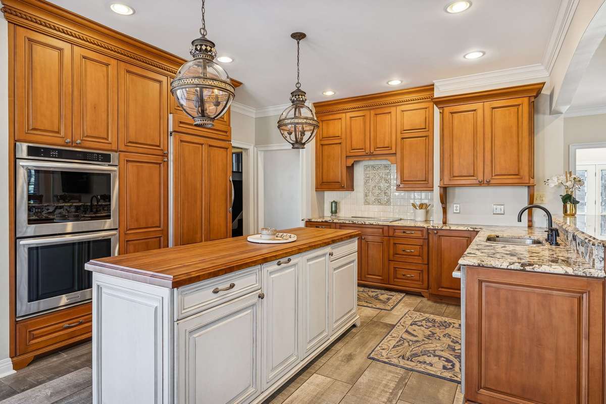 This luxurious kitchen features handcrafted Rudd cabinets, a WOLF induction stove, top of the line Bosch dishwasher, and much more hidden behind the doors..