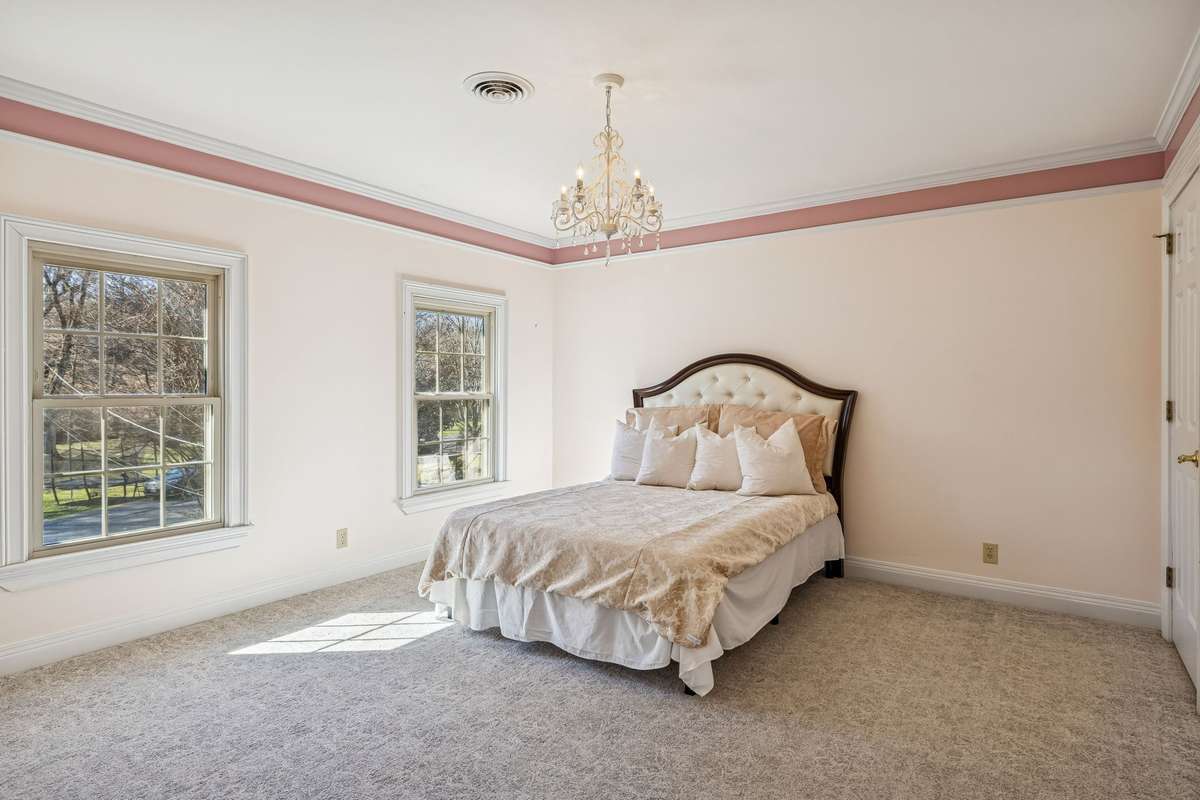Pretty in Pink! This spacious 2nd bedroom has a great view of the creek and front lawn. Elevated carpet with a 6-inch pad to make sure your toes are cozy when walking around in the morning.