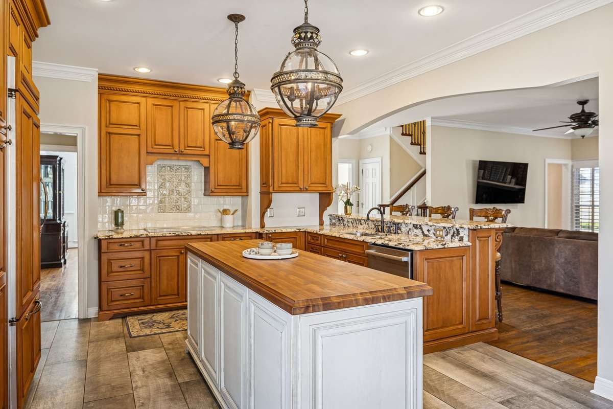 The spacious island houses the drawer microwave, the appliance caddy, storage, and a recycle bin. The butcher block countertop allows for additional prep space for cooking or having a buffet-style meal!