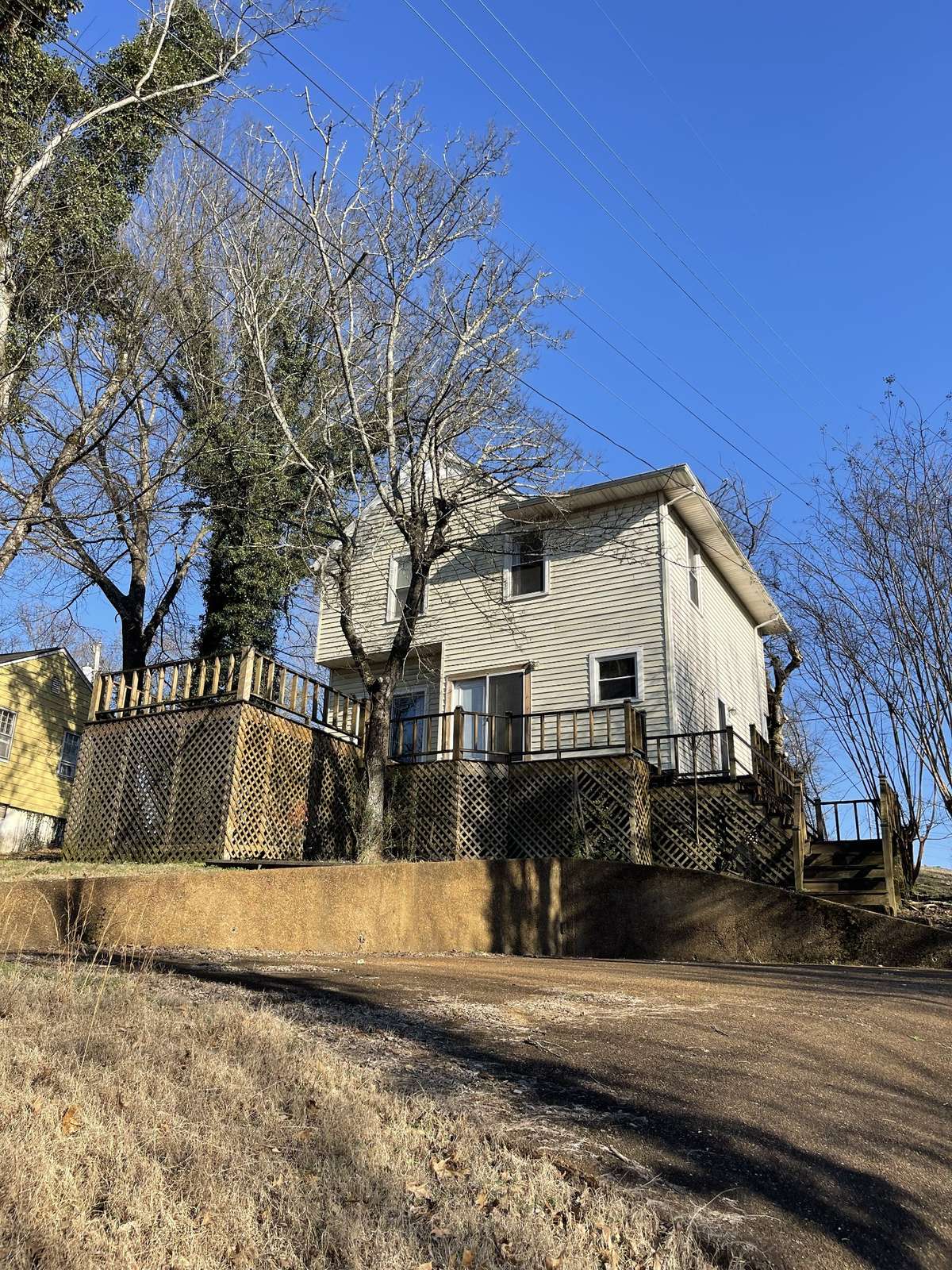 Back of the house, deck, and parking