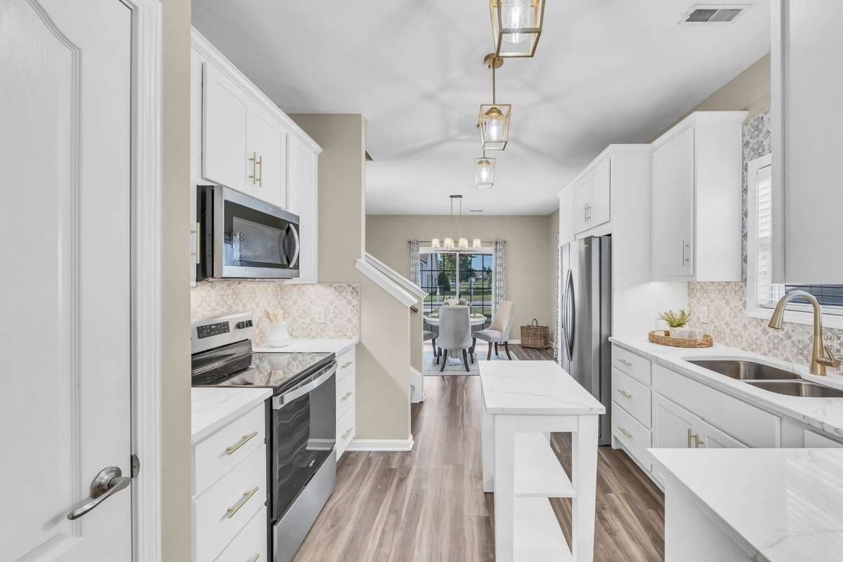 Quartz counters with gold veining, gold fixtures, gorgeous backsplash