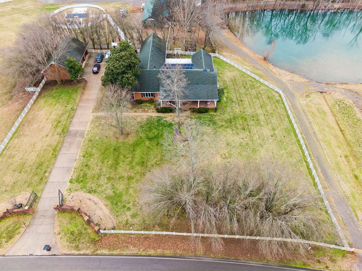 Aerial View of this Beautiful House, Detached Garage and Pond.