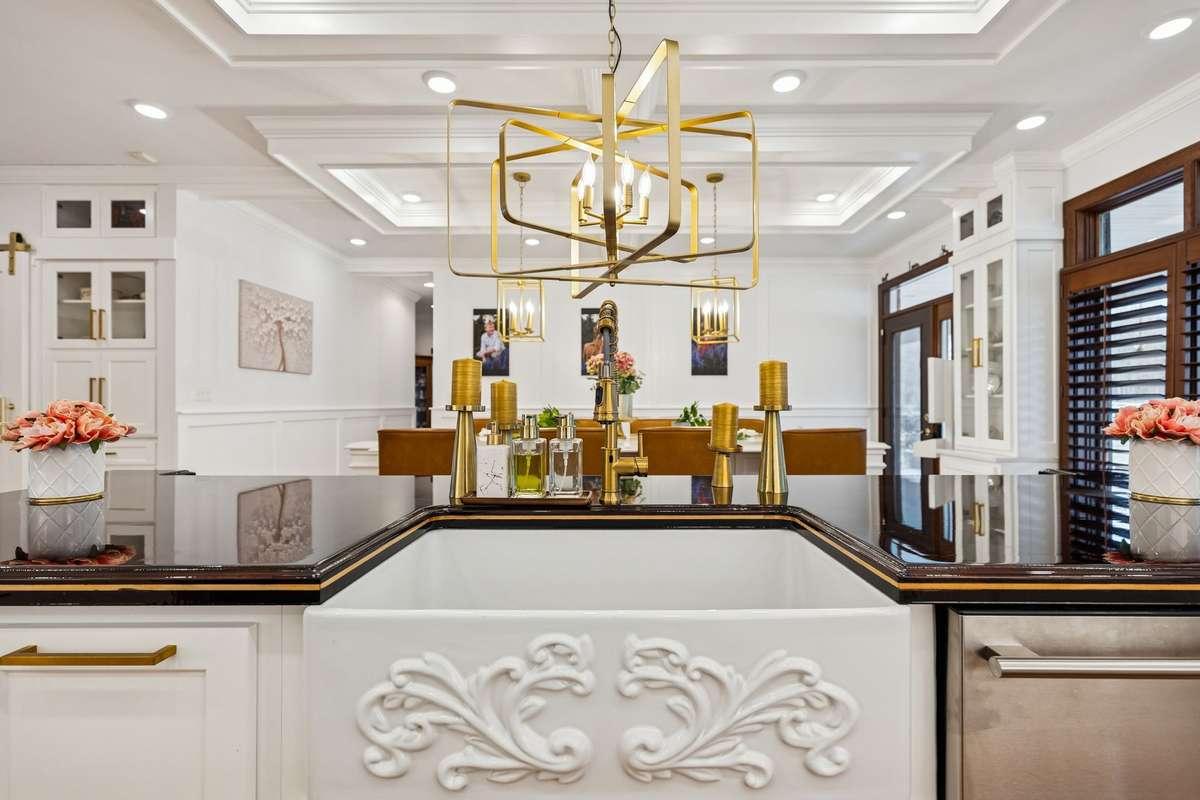 Gorgeous Kitchen Farm Sink and Champaigne Gold Lighting Fixtures.