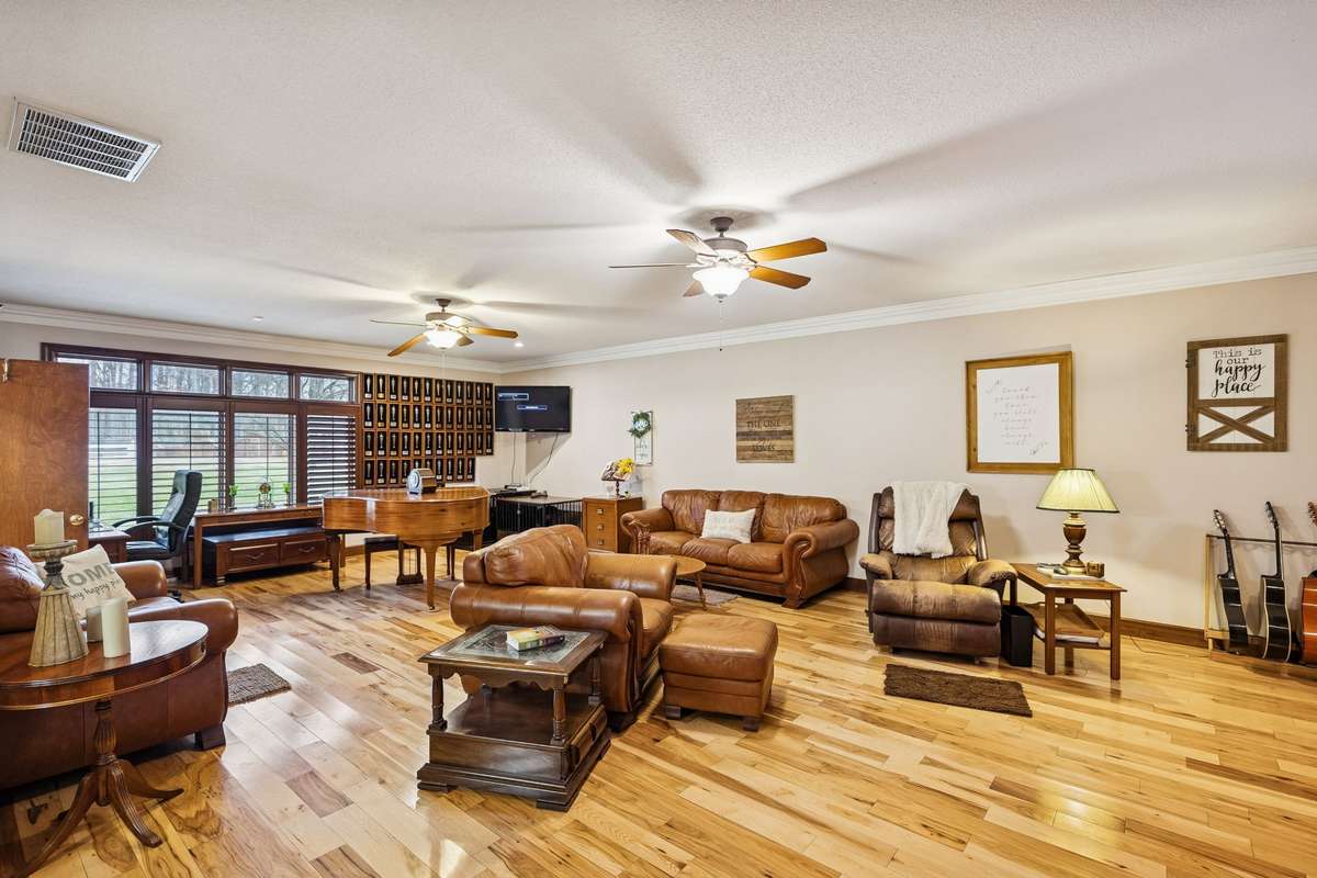 Spacious Living Room with Hardwood Floors and Extra Windows for Natural Light.