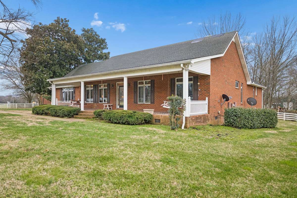 Large Covered Front Porch for Relaxing and Enjoying this Peaceful Country Setting.