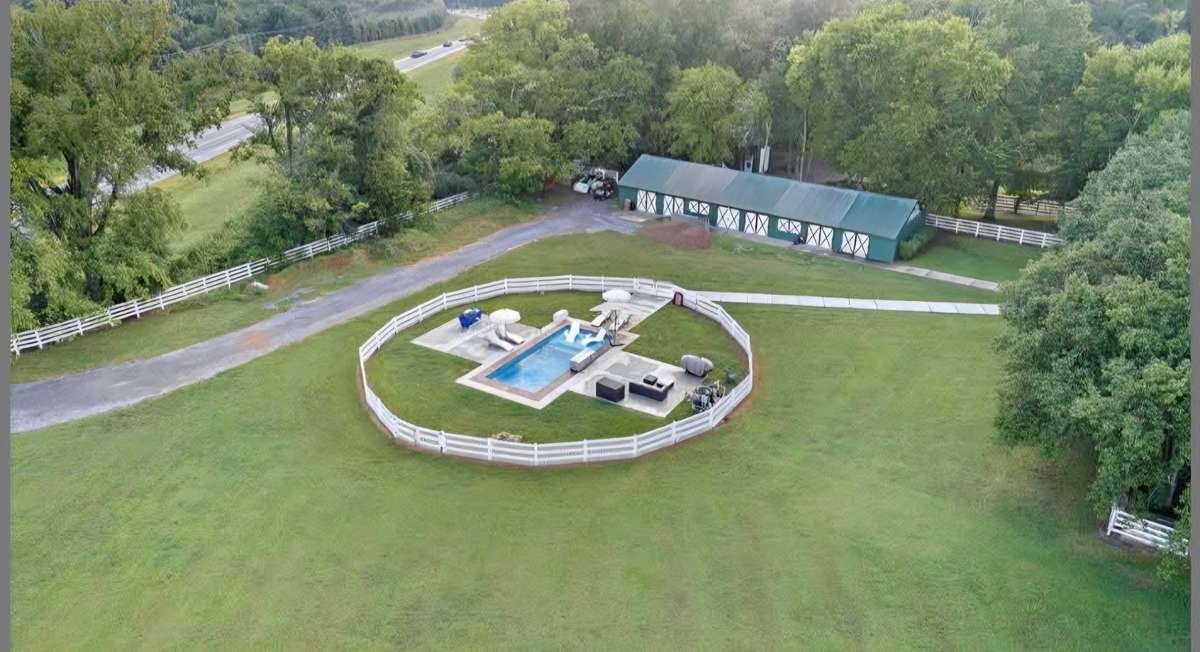 Spectacular In Ground Pool has Tanning Ledge and is completely fenced.