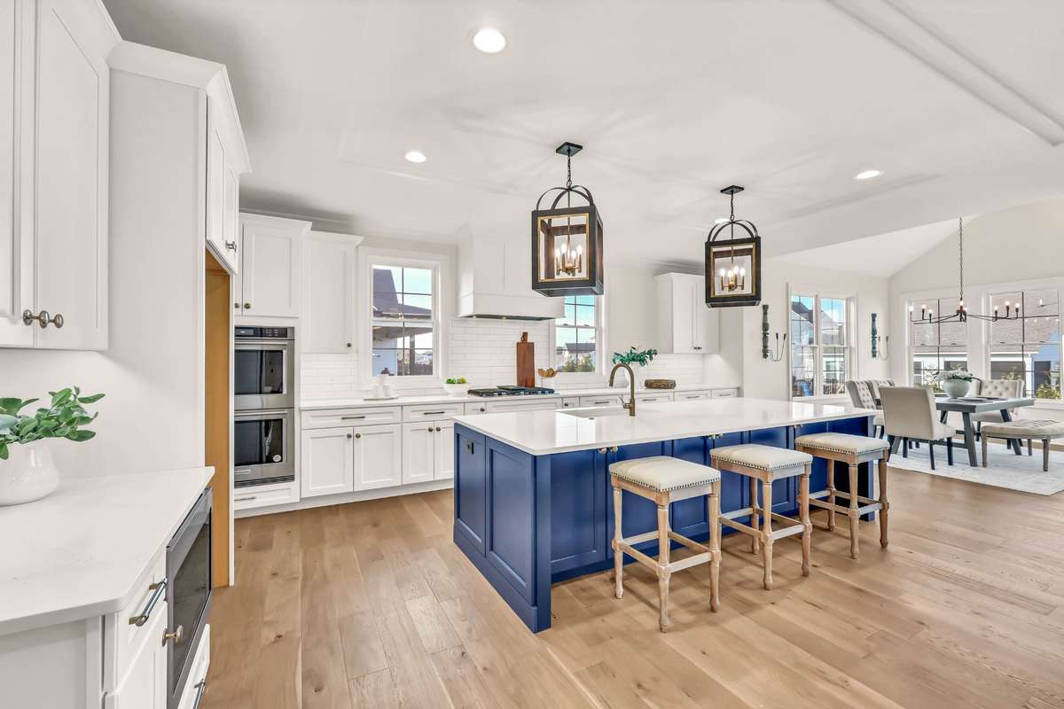 A dream kitchen, double ovens, gas range with griddle, and quartz counters.