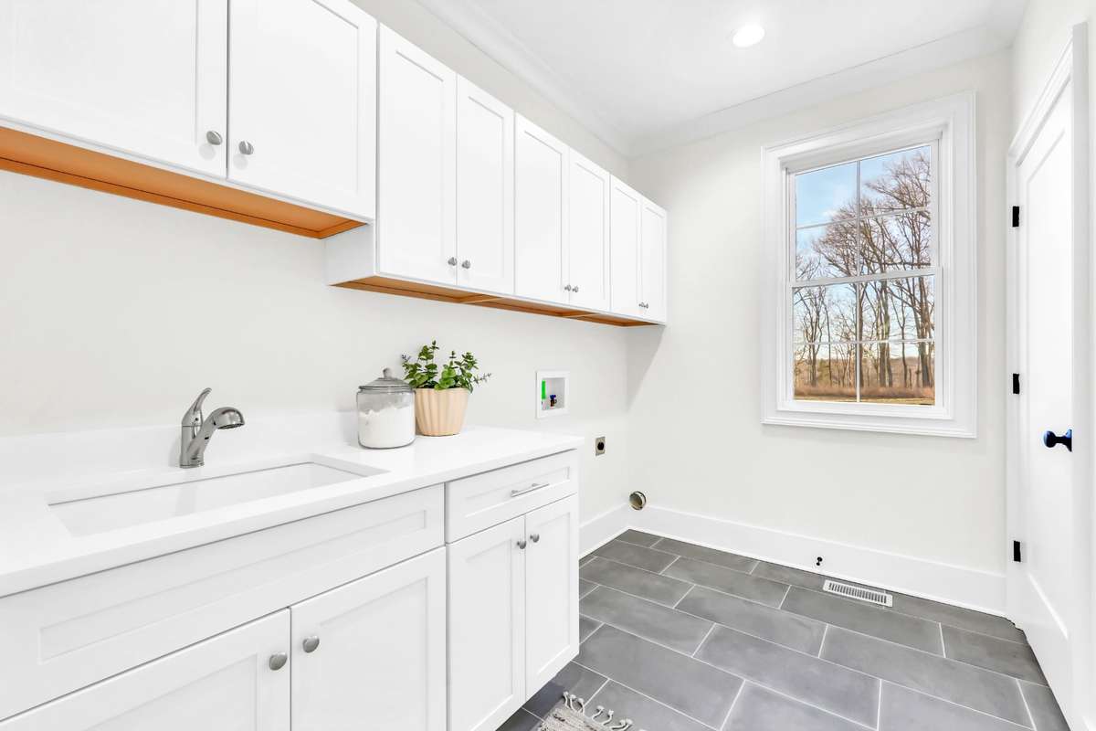 Primary bedroom connects to this luxury laundry room