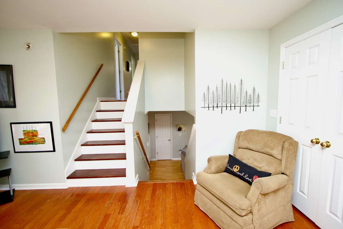 Doors behind the chair lead to a nice size laundry room. Steps go up to next level.