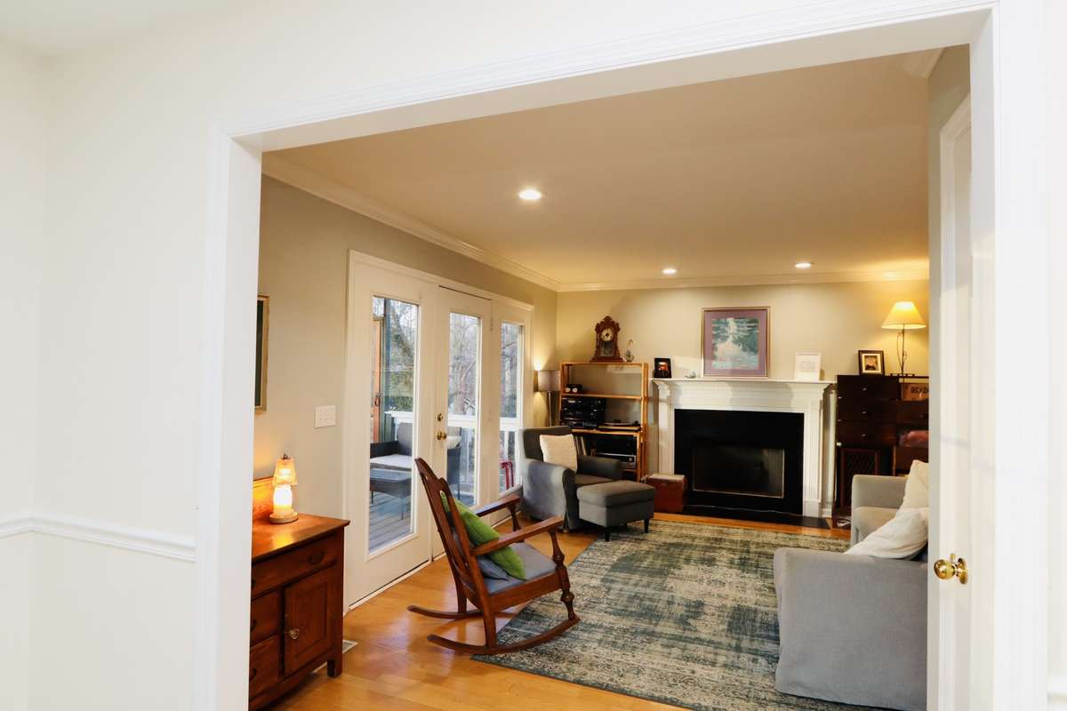 Great room complete with a fireplace, hardwood floors and sunlight coming in!
