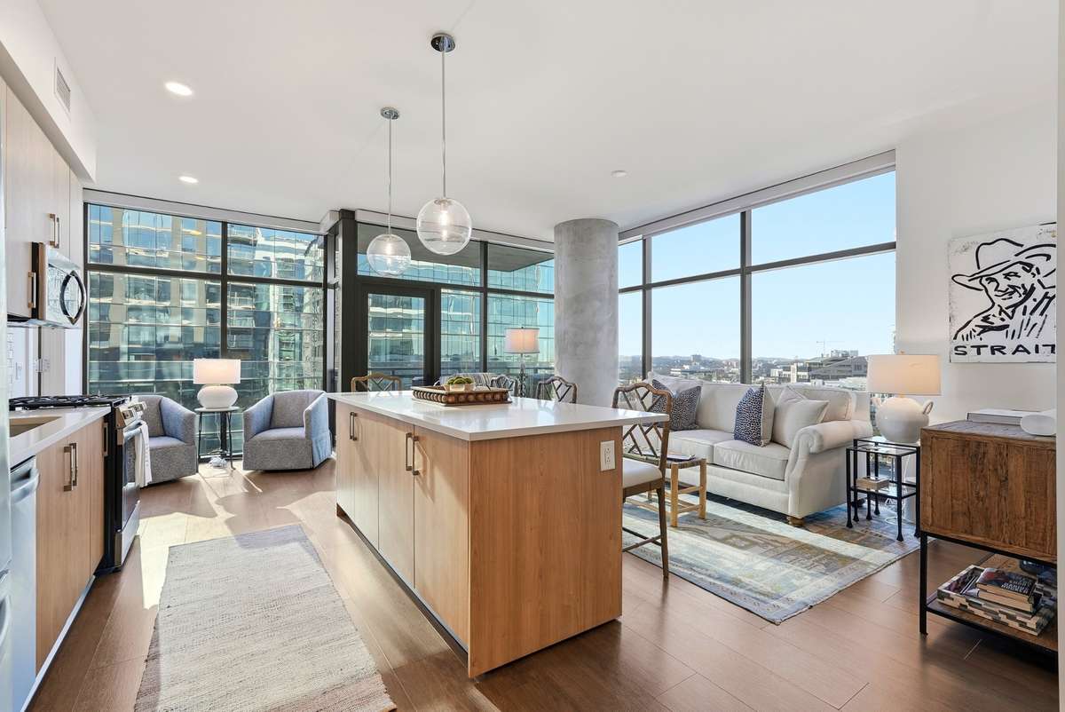 Floor-to-ceiling windows, an oversized island, and endless natural light — modern city living at its best.