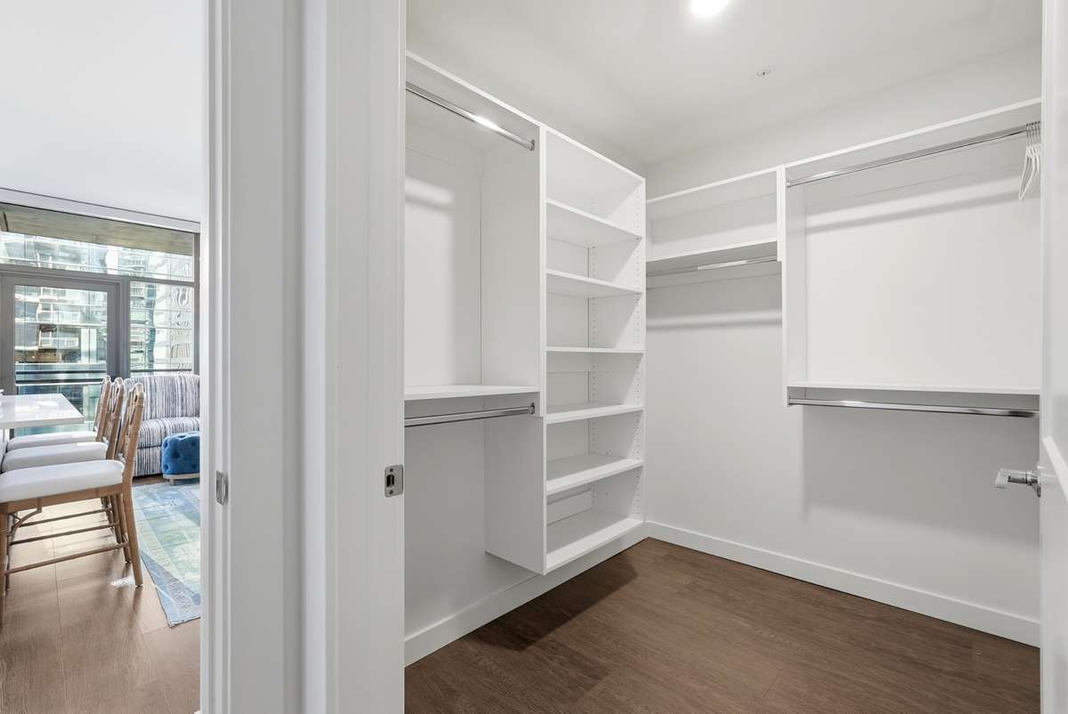 Large closet built out with custom shelving in 2nd bedroom
