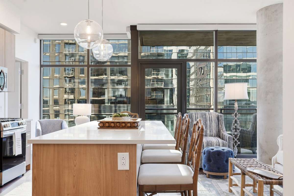 Oversized quartz island with seating, seamlessly flowing into the living area—ideal for hosting.