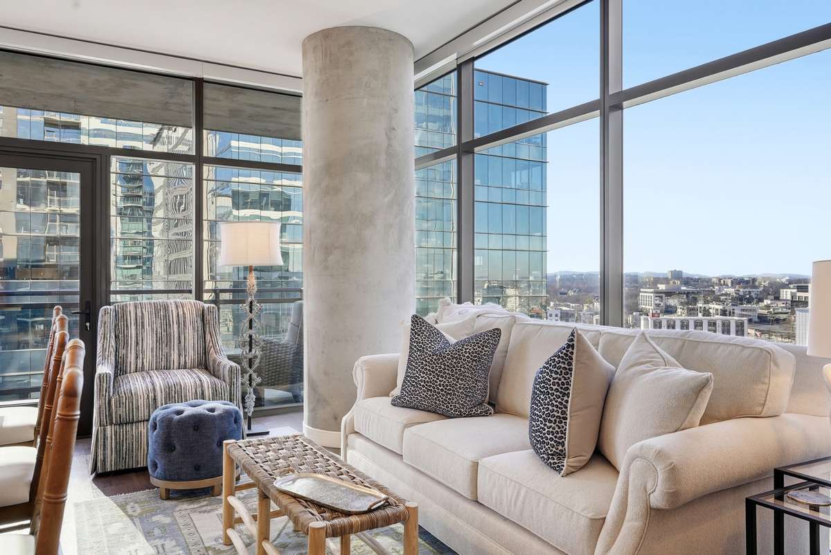 The kitchen and living space is surrounded by full glass.