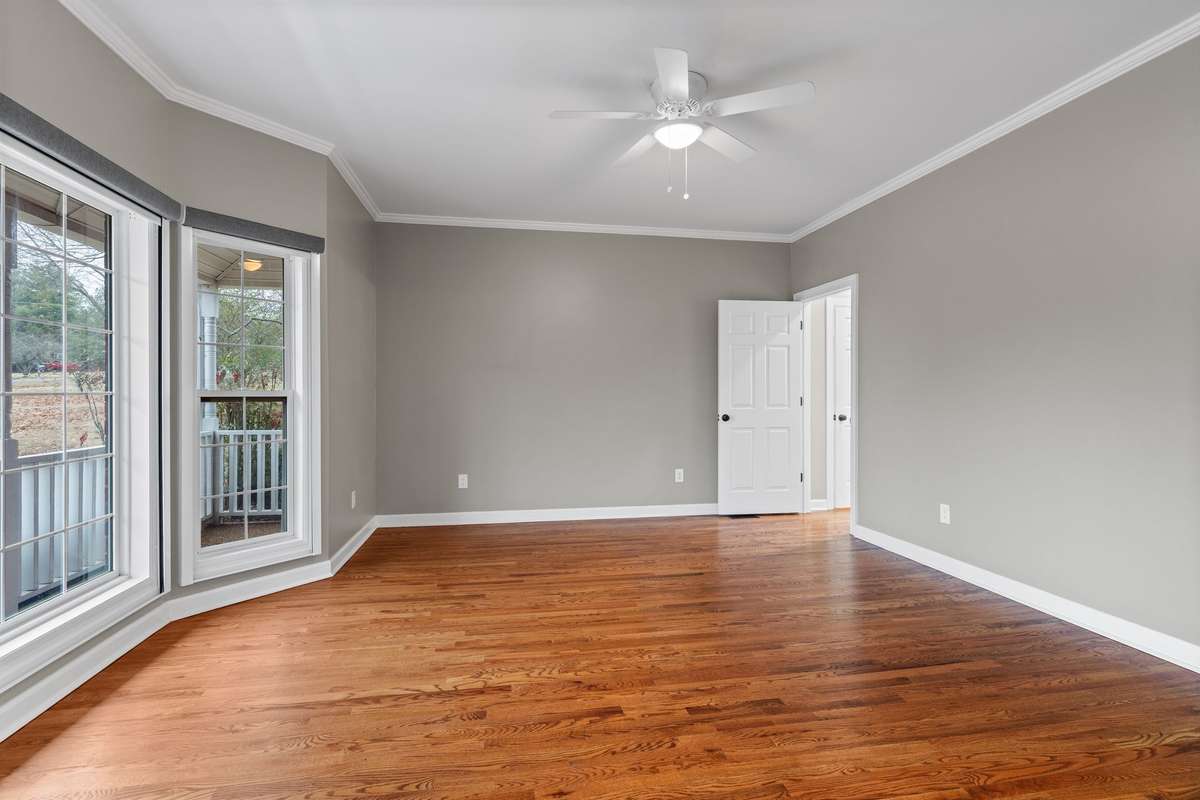 Owner's suite with hardwood floors and new remote controlled black out shades.