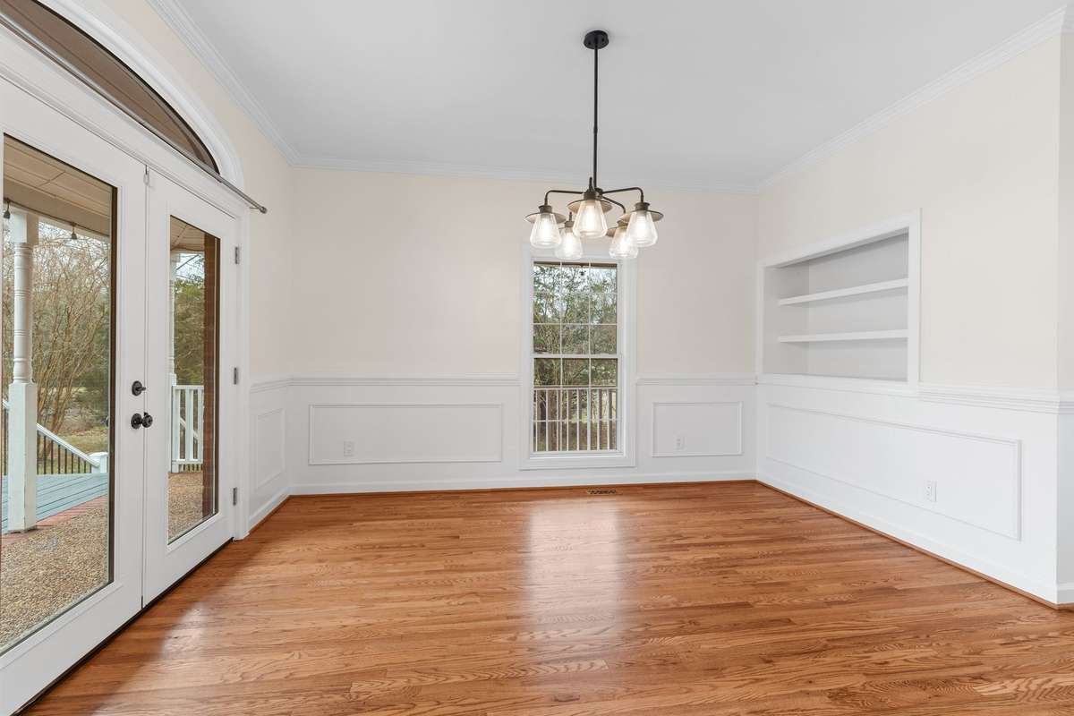 Formal dining room has hardwood floors, and built in shelving