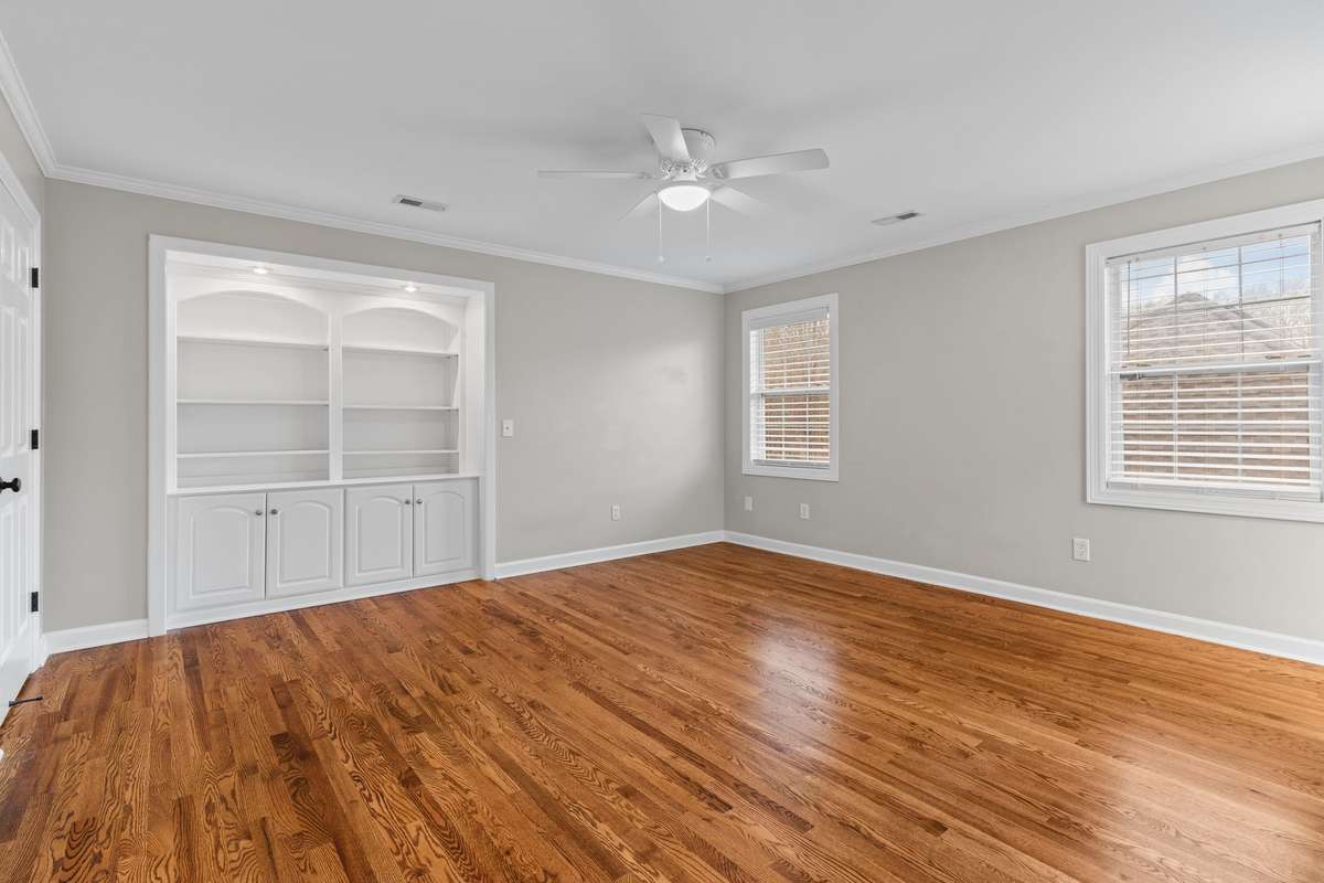 3rd bedroom is spacious with hardwoods, built in book case.