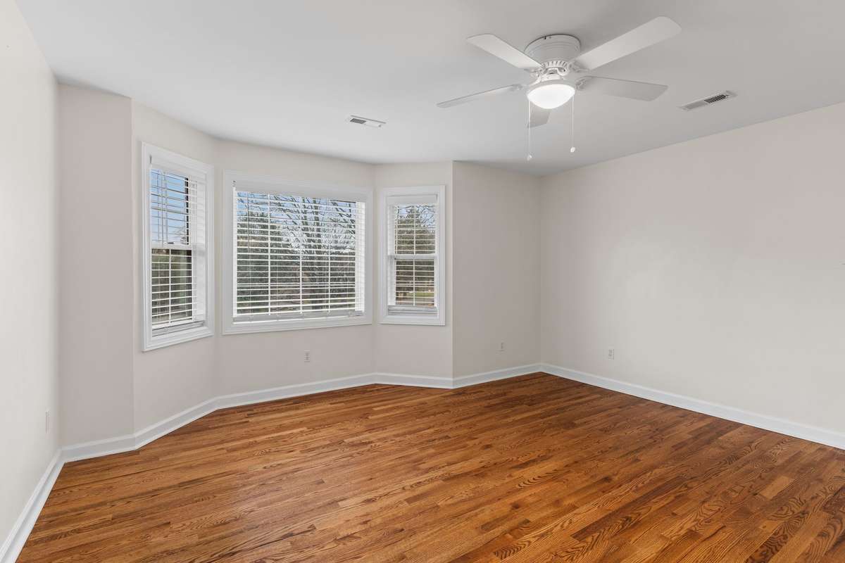Second bedroom with lots of natural light, hardwood floors, walk in closet and en suite bath