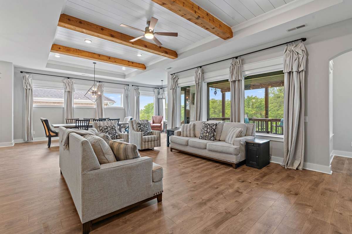 Living area with huge windows that gives it a lot of natural light and great views out to the backyard