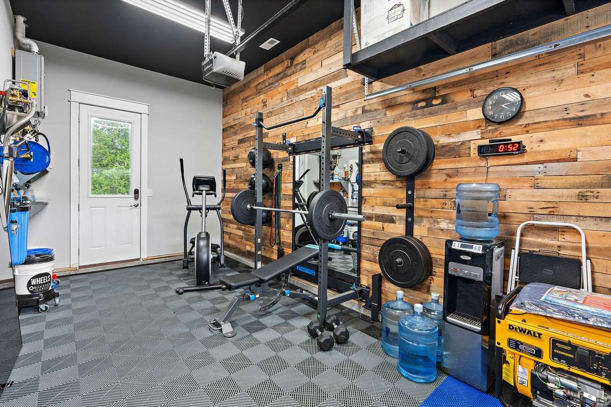 Workout area in the 3rd car garage with access to the backyard