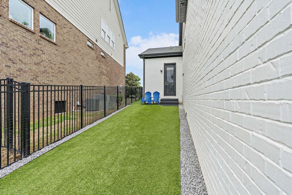 This is turf on the side that can be used as a play area or a place for your dogs to go run around without getting muddy
