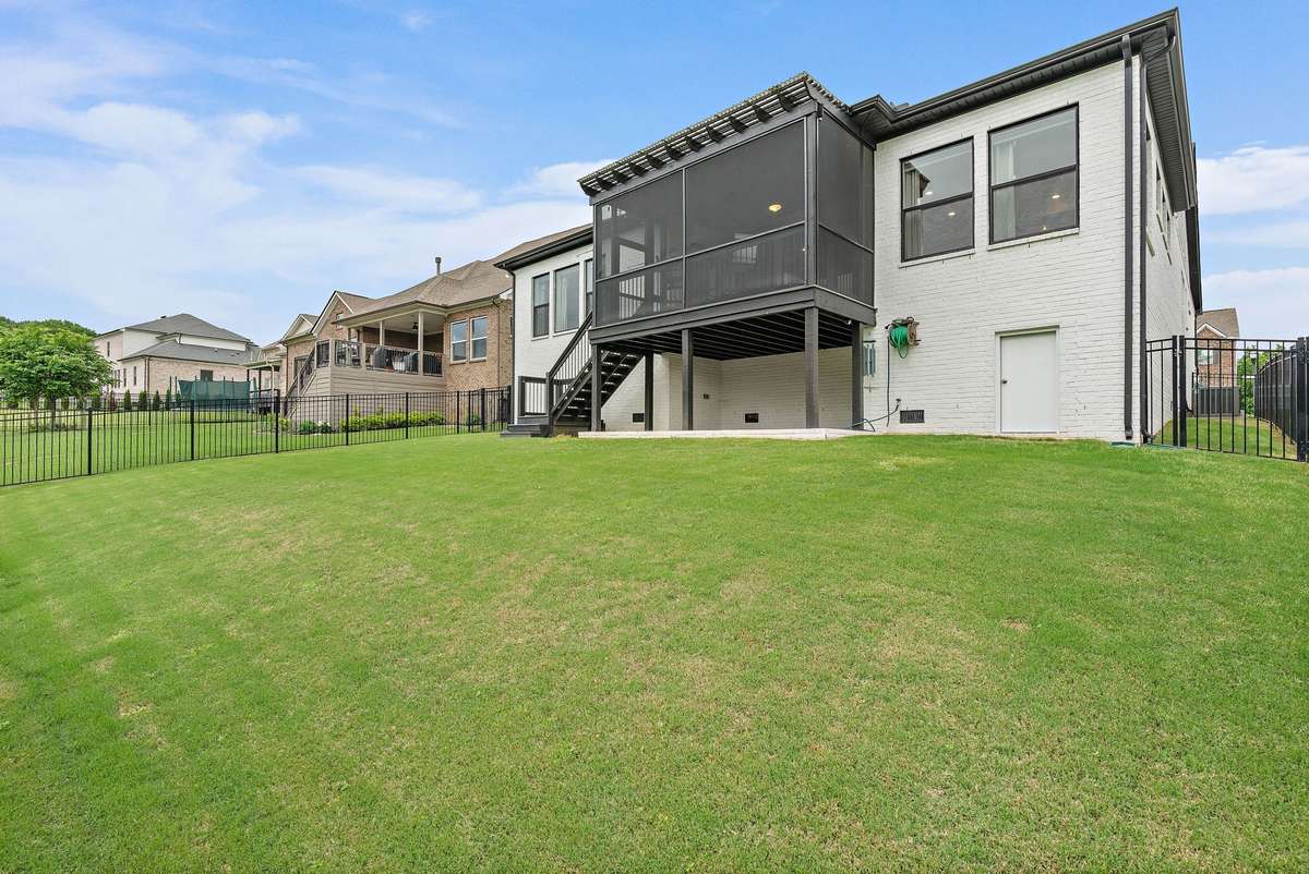 Fenced in backyard and view of the back of the home