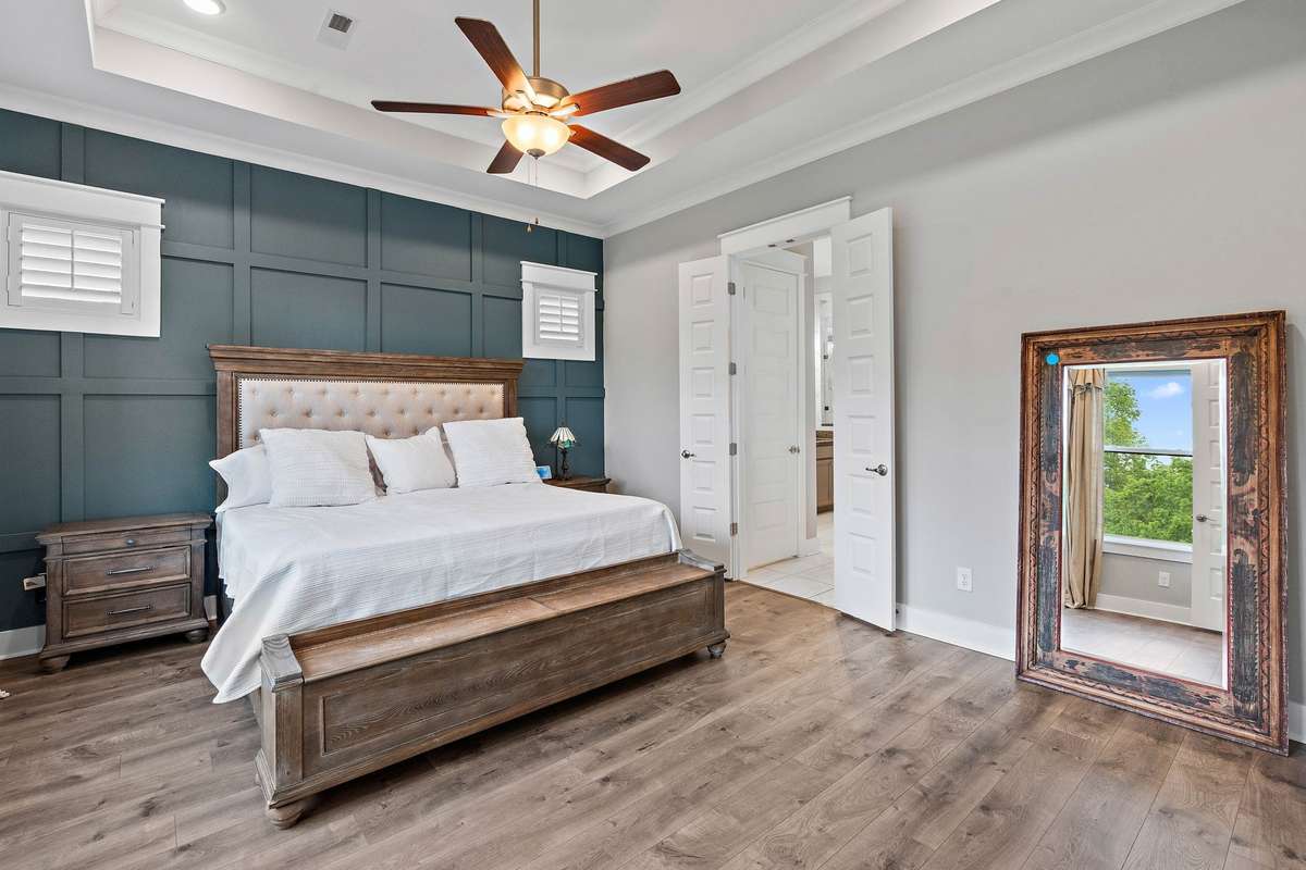 Primary bedroom at the back of the home with tray ceilings