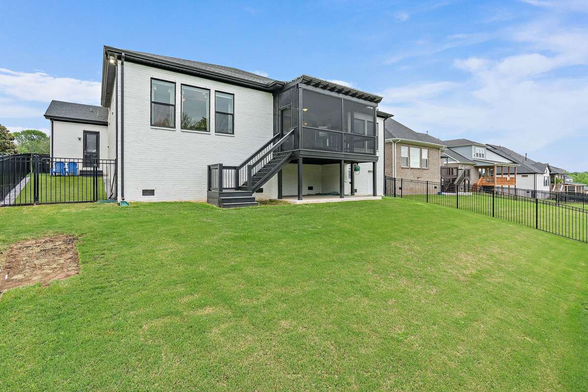 Fenced in backyard and view of the back of the home