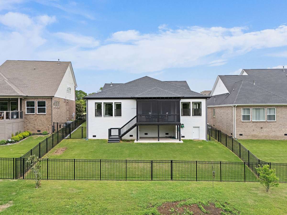 Fenced in backyard and view of the back of the home
