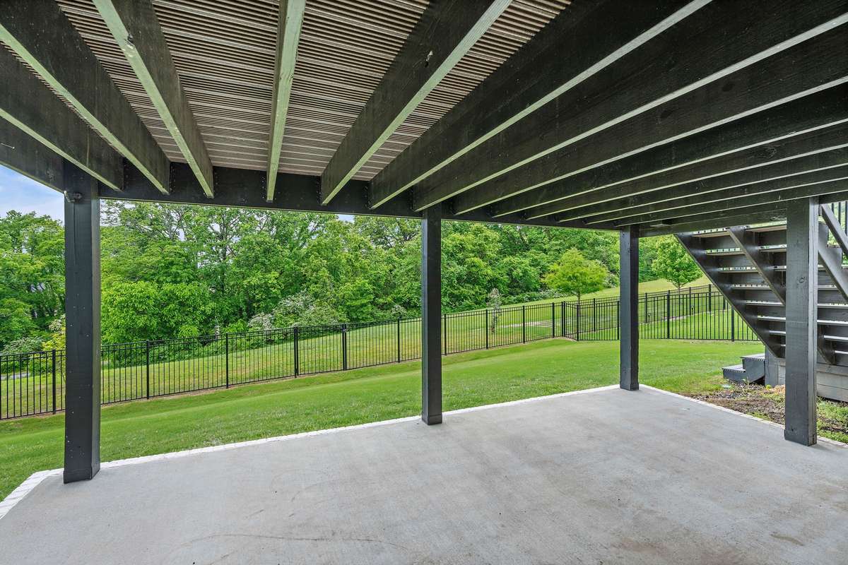Under the deck patio space that can be used as storage or another seating area