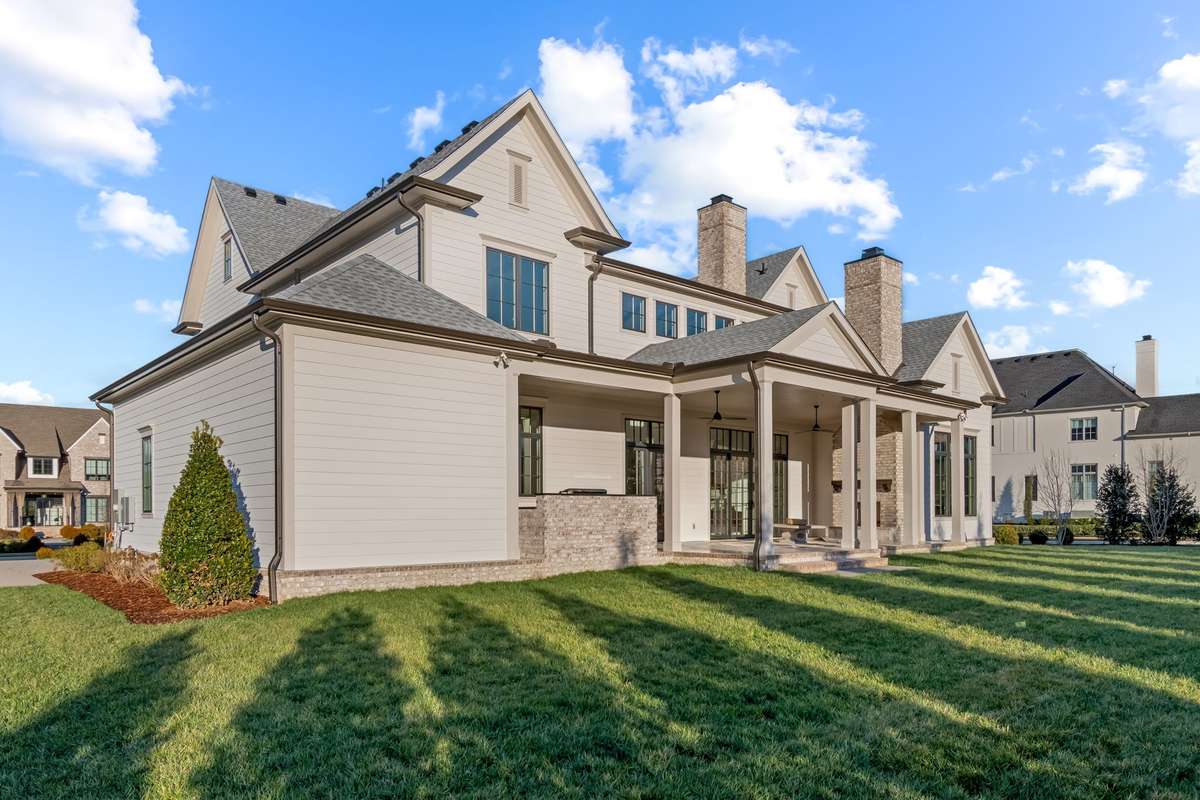 Rear porch is perfect for outdoor dining, living, and grilling