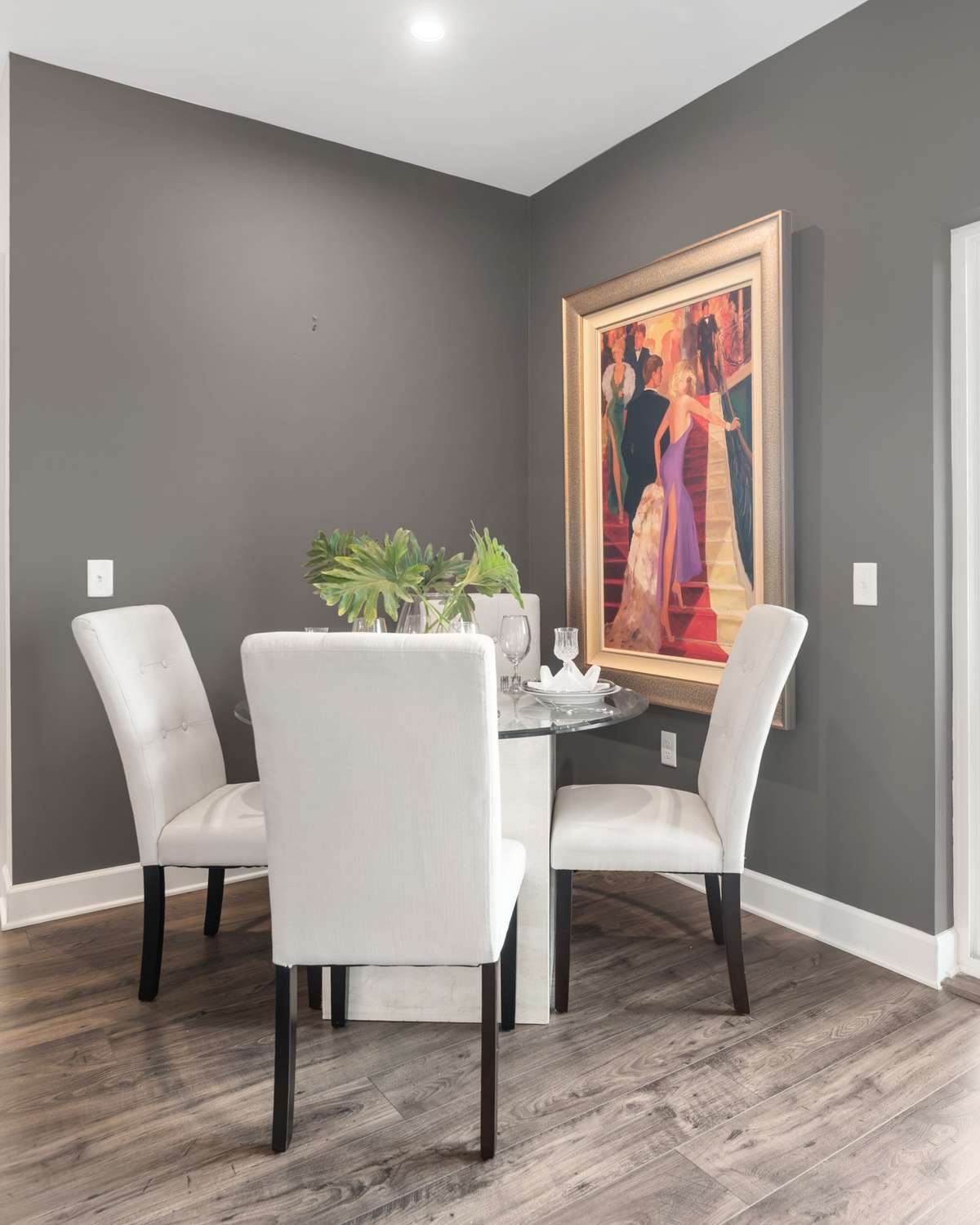 A cozy, intimate space for entertaining with natural light and a sophisticated accent wall.