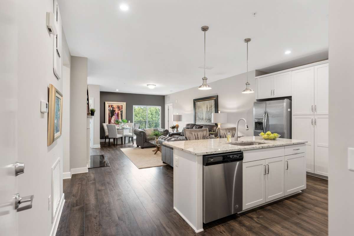 Spacious, light-filled living with upgraded gas fireplace, dining nook, and access to the private balcony with treetop views.