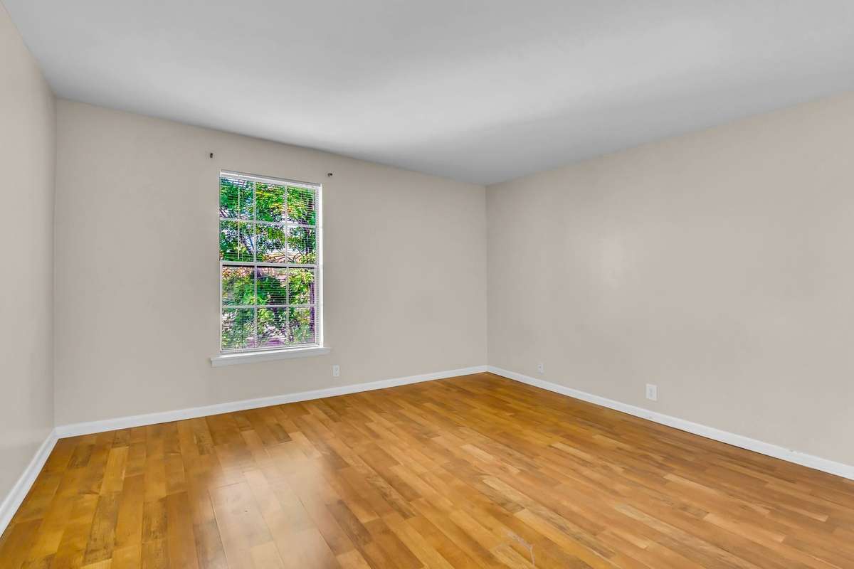 The generously-sized bedroom could easily accomodate a queen or king bed. New LVP flooring has been laid in the bedroom.