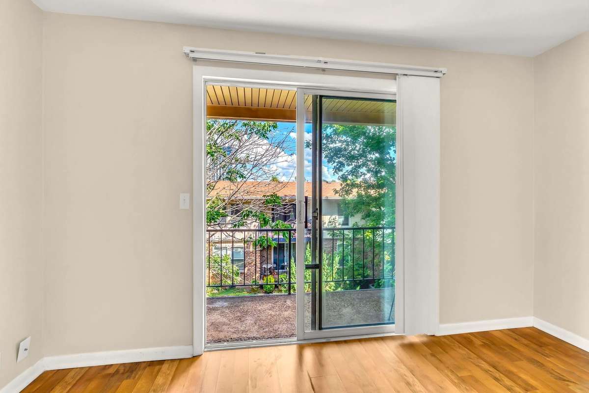 Sliding glass doors open out onto a lovely balcony.