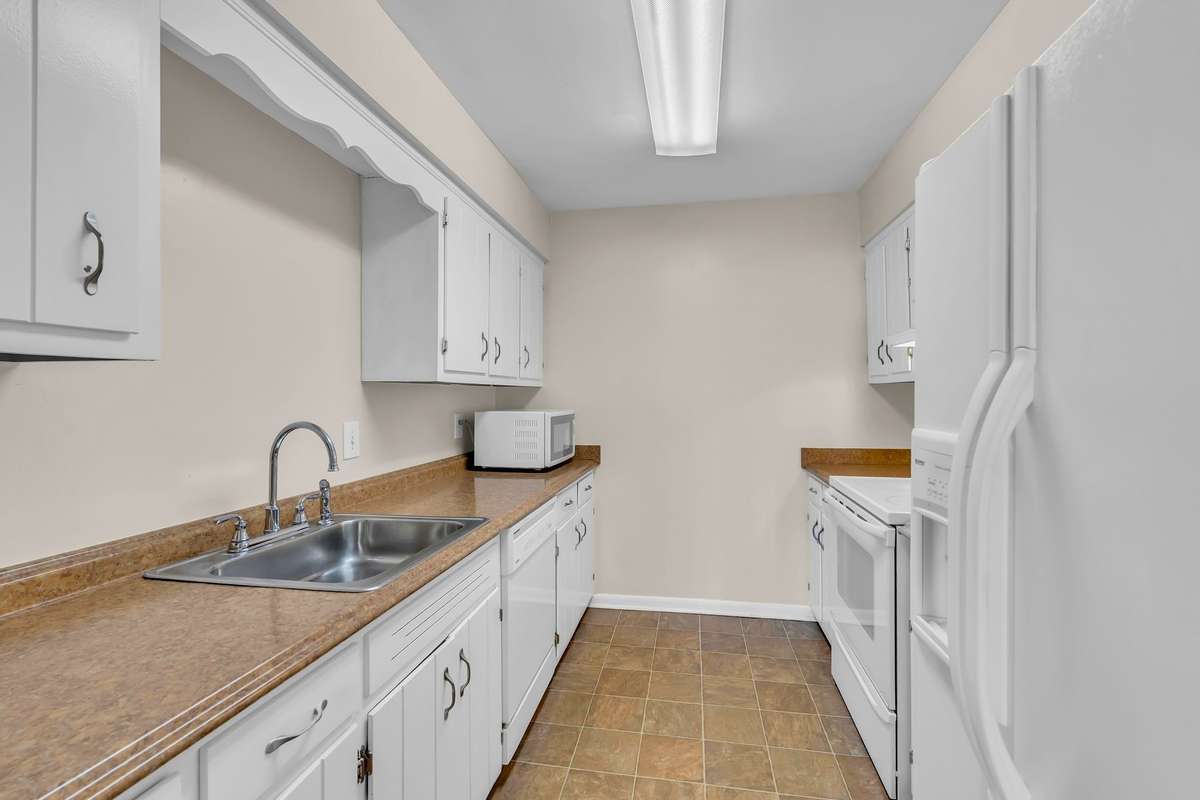 The galley-style kitchen has plenty of cabinets and ample counter space.