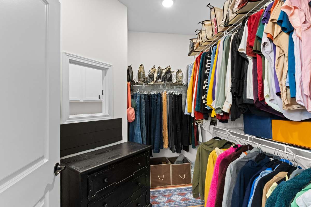 Walk in primary closet is spacious with drop zone from closet to laundry.