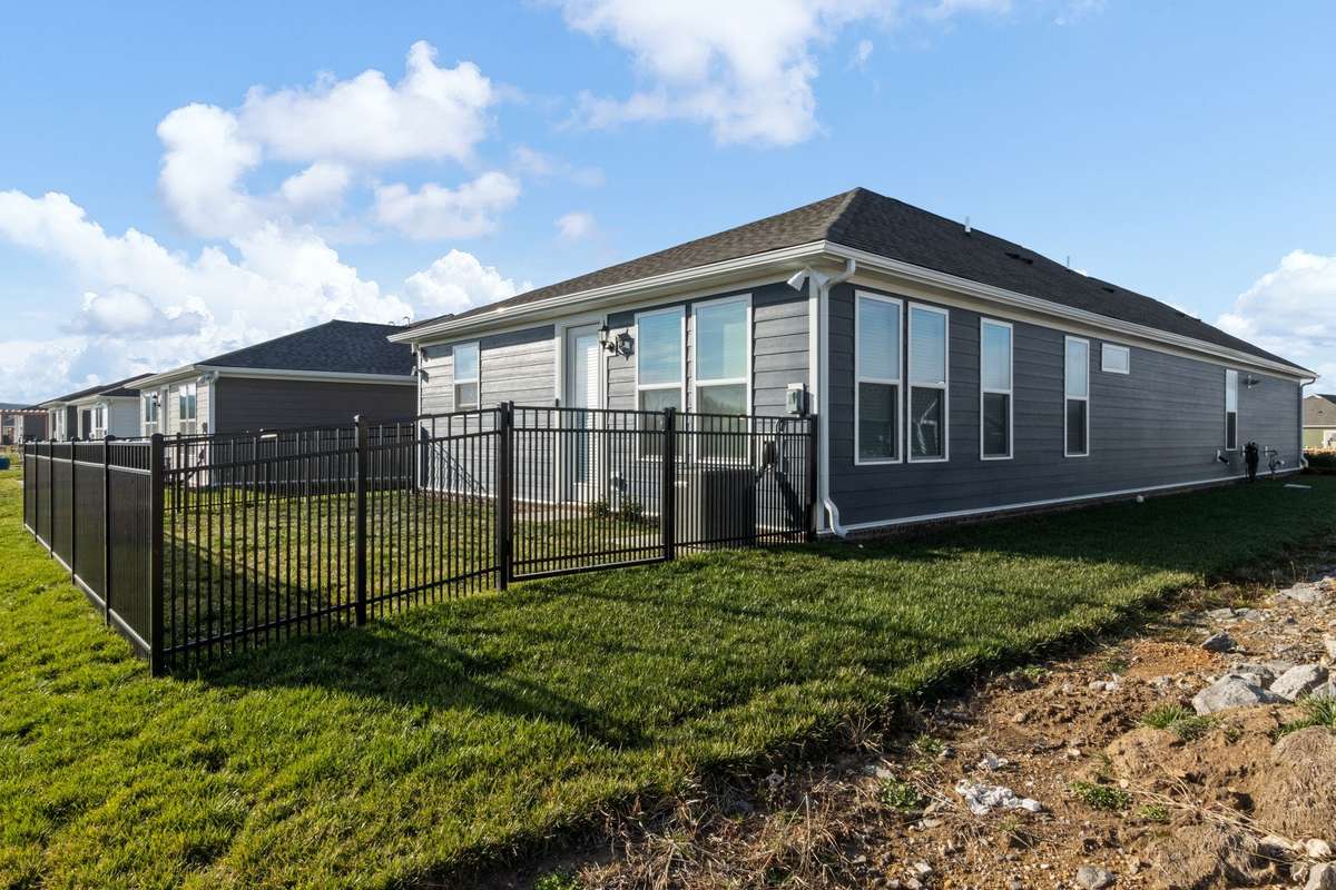 Front and back yard have sod with wrought iron fence in back.