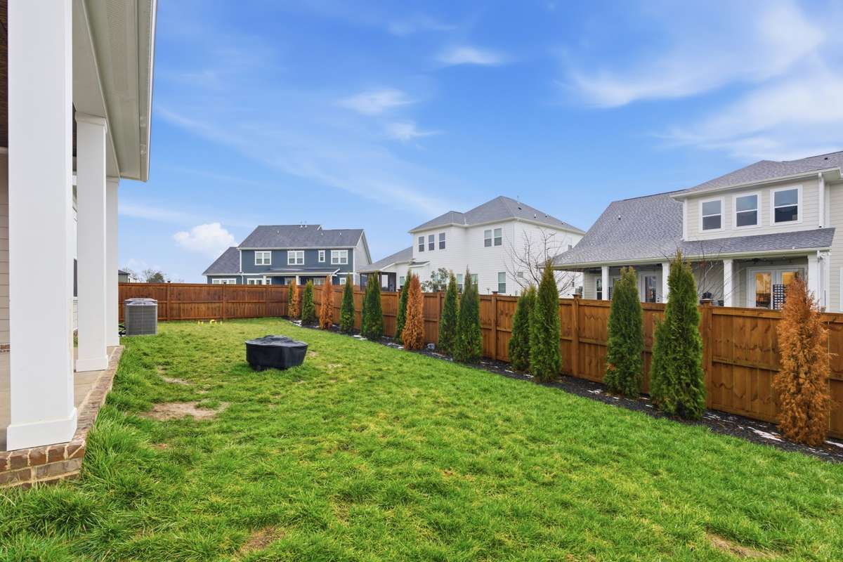 A fully fenced in backyard and growing trees allow a peace of mind with added privacy.