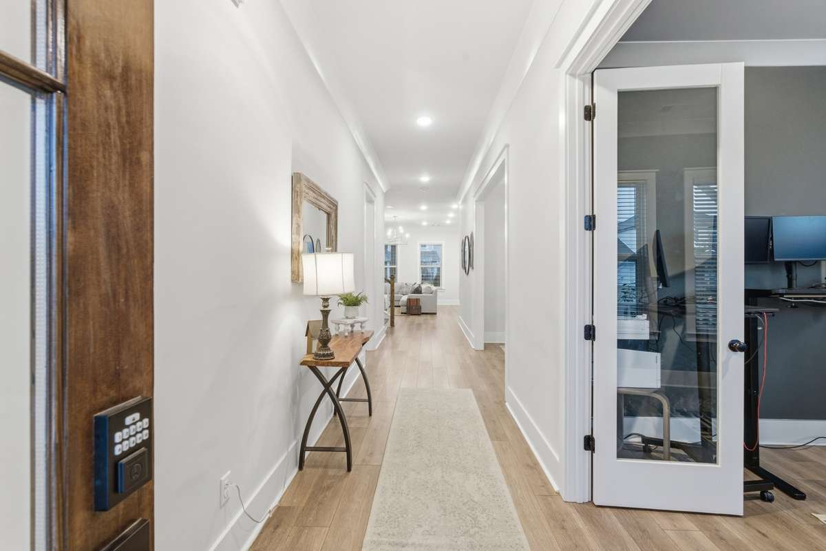 Off the entry way, enjoy a private and fully functioning office space. Complete with glass-paned doors and space to set up your work area.