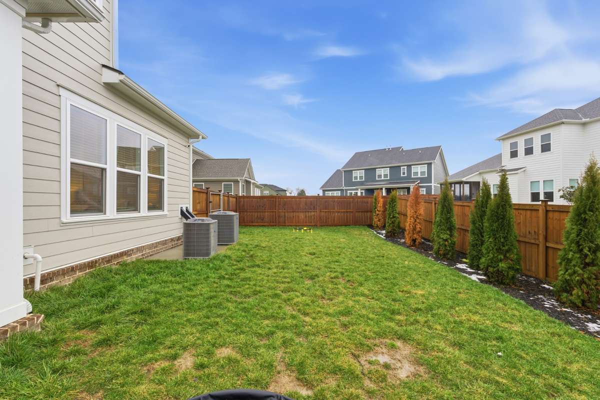 A fully fenced in backyard and growing trees allow a peace of mind with added privacy.