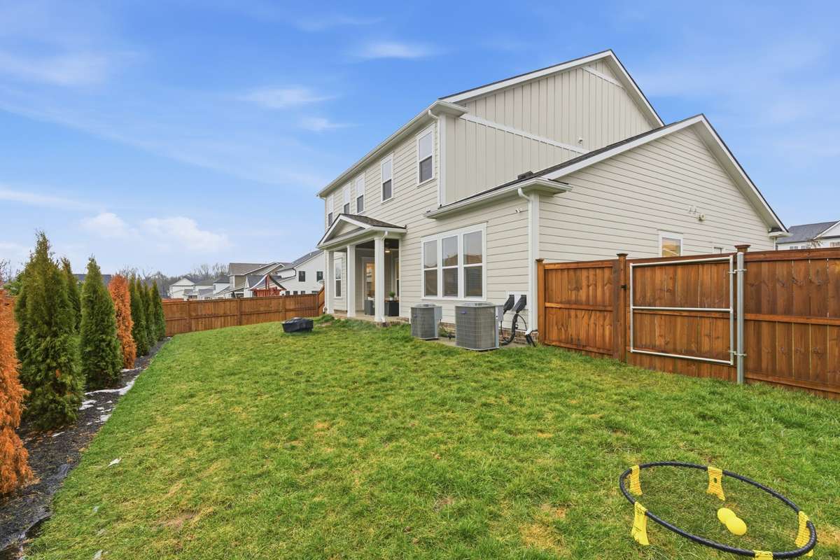 The large backyard boasts enough space for families to enjoy all their favorite games and hobbies.